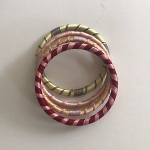 Set of four colorful thread wrapped bangles.